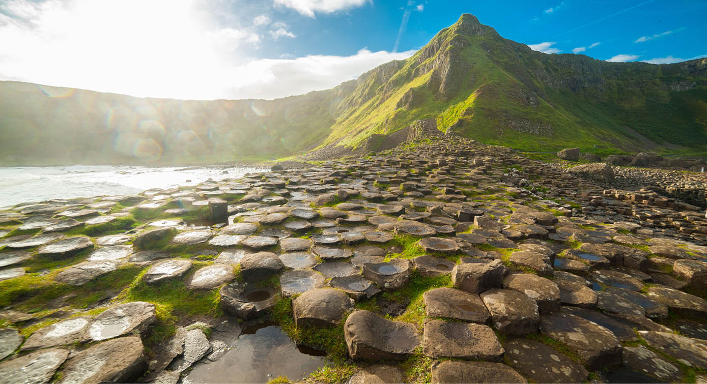 The Giant's Causeway at dawn on a sunny day with the famous basalt columns, the result of an ancient volcanic eruption  County Antrim on the north coast of Northern Ireland, UK