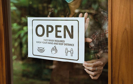 wear masks, keep your distance and wash hand sign on shop front door when new normal during coronavirus outbreak in the city open her shop for business
