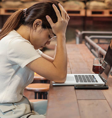 Casual businesswoman serious and concerned with laptop computer, asian woman stressed and tired from work in workspace or cafe  busy business, workload and unhappy concept