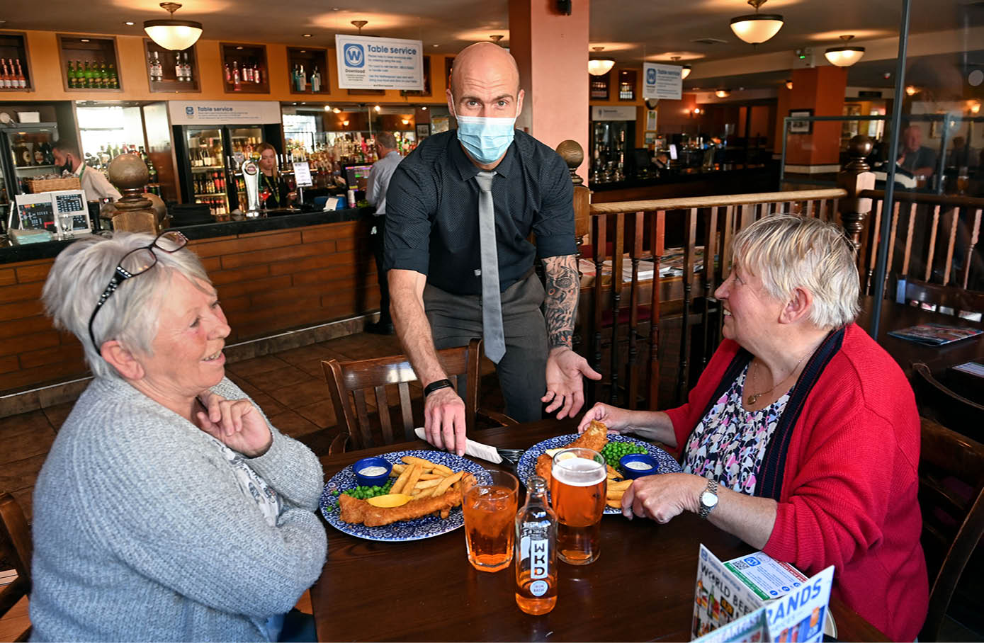 17 6 2021  Photo By Justin Kernoghan Belfast Live Wetherspoons manager Jordan Wilson serving Customers Maxi Massey (left) nd Rudy Hanna at The Spirit Merchant, Newtownards, Northern Ireland 