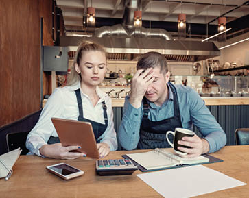 Young entrepreneurs overwhelmed by finance problems - Nervous manager checking restaurant finance - Failure in small-business concept