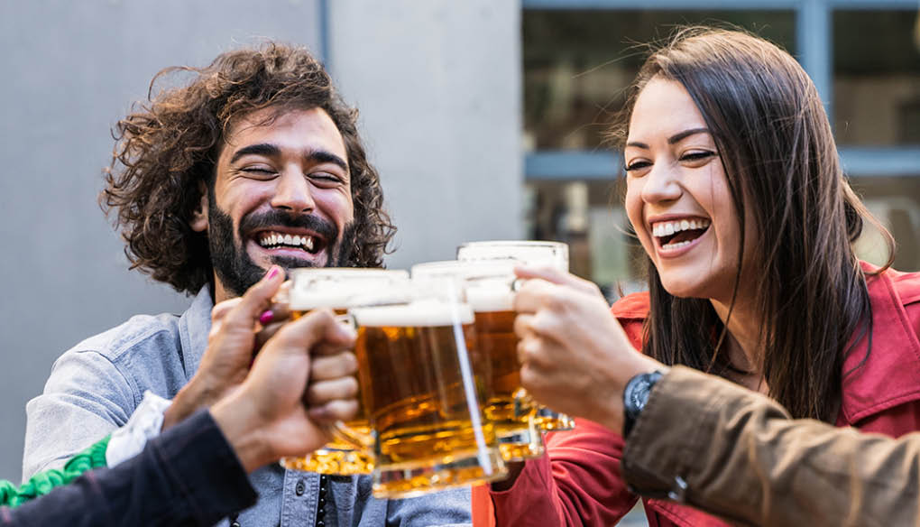 Group Of young Friends Enjoying Beer Drinks In Bar