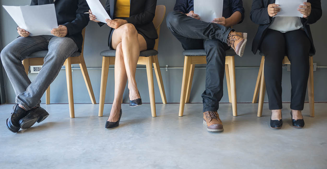 Group of peoples are sitting to review the documents while waiting for a job interview 