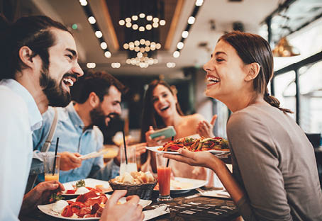 Group of Happy friends having breakfast in the restaurant