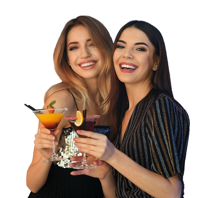 Beautiful young women with martini cocktails in bar