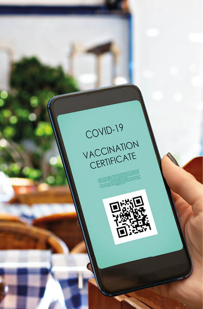 vaccination certificate,vaccine passport digital application of covid vaccine for for for visiting restaurants and public places, hand with smartphone and qr code in city cafe