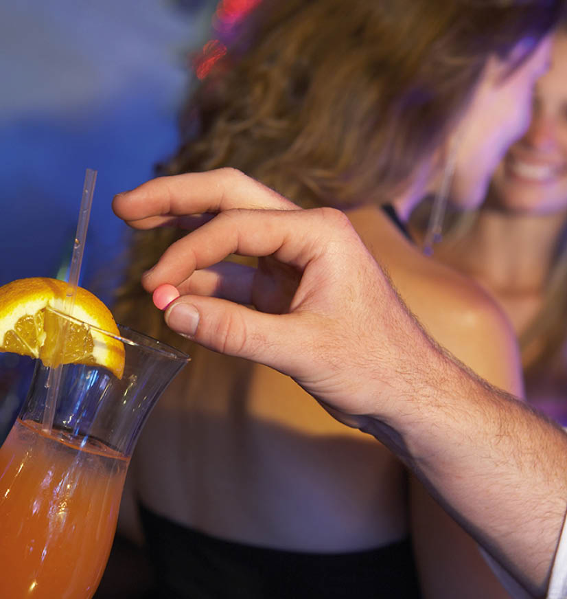 Man Drugging Woman's Drink In Bar