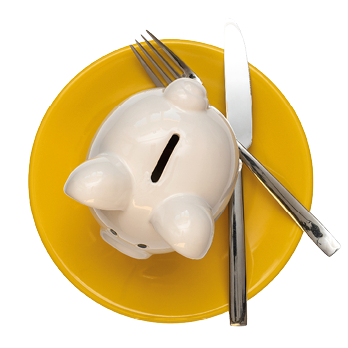 Savings consumer concept  Piggy bank on the yellow plate with fork and knife,isolated on white