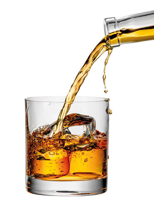 whiskey being poured into a glass