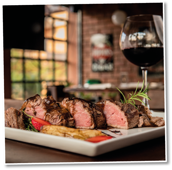Delicious dish made from beef served with a glass of wine