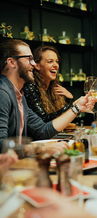 Group of best friends sitting in restaurant, making a toast and celebrating.