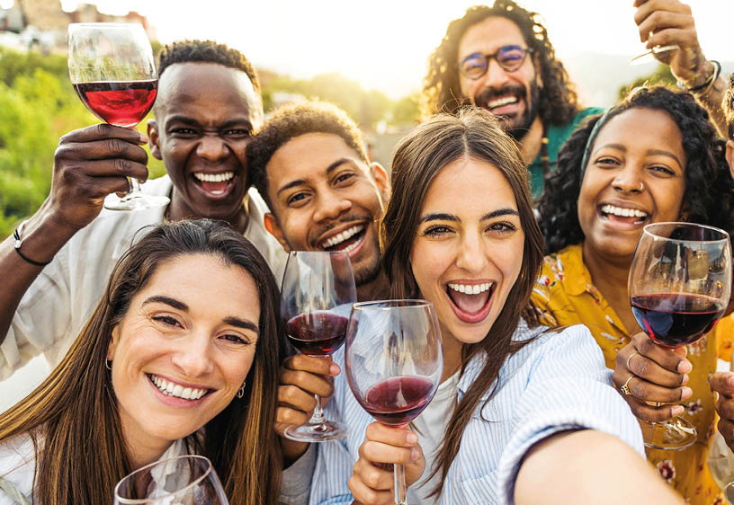 Multiracial friends drinking red wine outside at farm house vineyard countryside - Group of young people taking selfie picture outdoor - Life style concept with guys and girls enjoying summer vacation