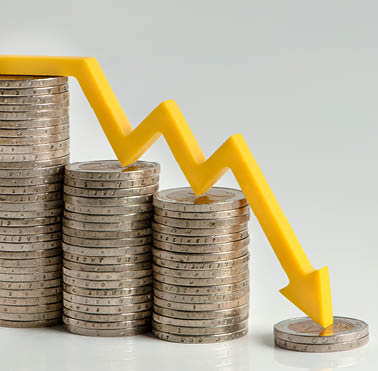 Inflation. The recession of the economy and the euro. The concept of economic collapse and the collapse of the stock exchange in the euro zone. Stacks of coins and a graph arrow pointing down.