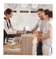 Young couple paying for hotel room at reception