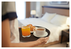 Waitress bringing breakfast to the hotel room