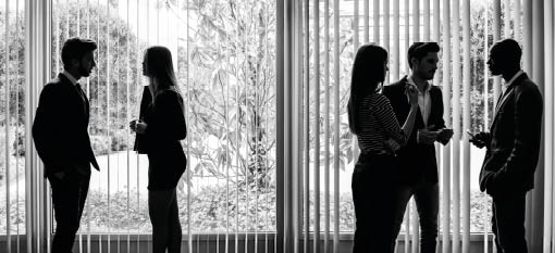 Several silhouettes of businesspeople interacting background business centrer