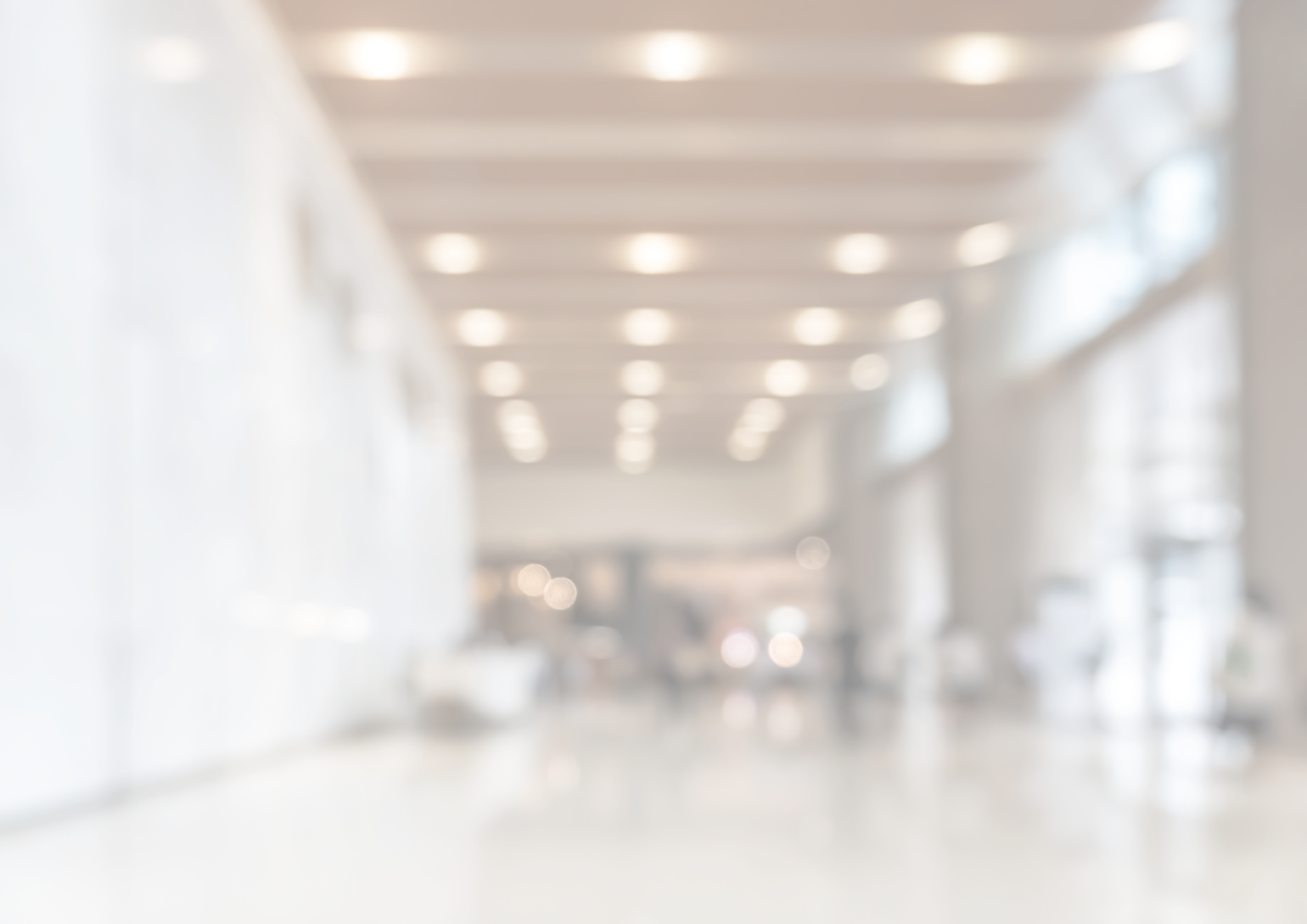 Blurred office building lobby or hotel blur background interior view toward reception hall, modern luxury lounge, white room space with blurry corridor and building glass wall