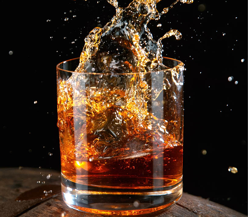 Whiskey Liquid falling into Glass, Freeze Motion.