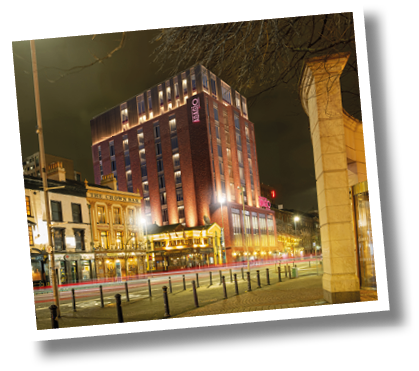 A tall brick building with a red roof. Description generated by AI