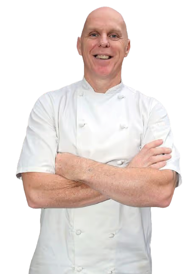 A man wearing a white shirt and apron. Description generated by AI