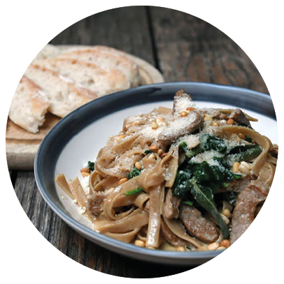 A bowl of noodles with meat and vegetables. Description generated by AI