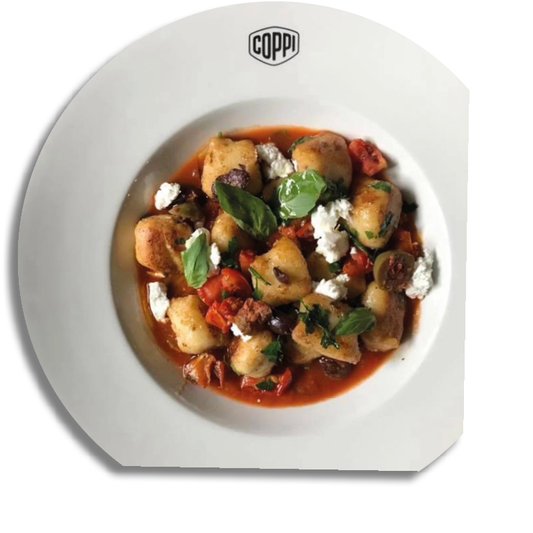 A white plate with a red sauce and a variety of food items on it. Description generated by AI