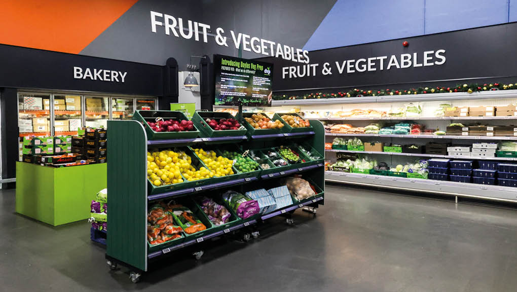 A fruit and vegetable stand in a grocery store. Description generated by AI