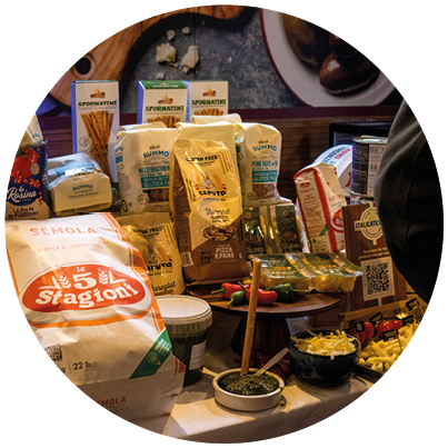 A table full of food items including pizza, bread, and various other foods. Description generated by AI