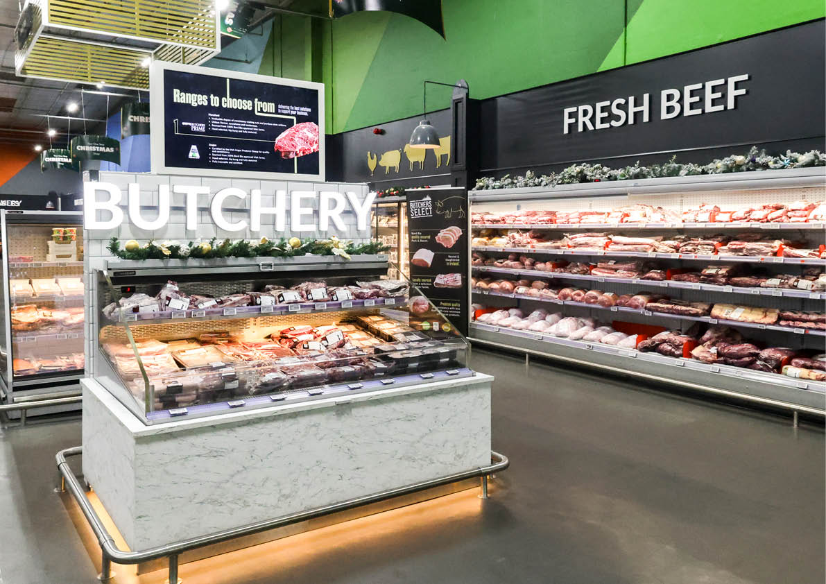 A store with a sign that says “Fresh Beef." Description generated by AI
