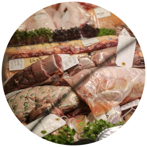 A display of raw meat in a store. Description generated by AI