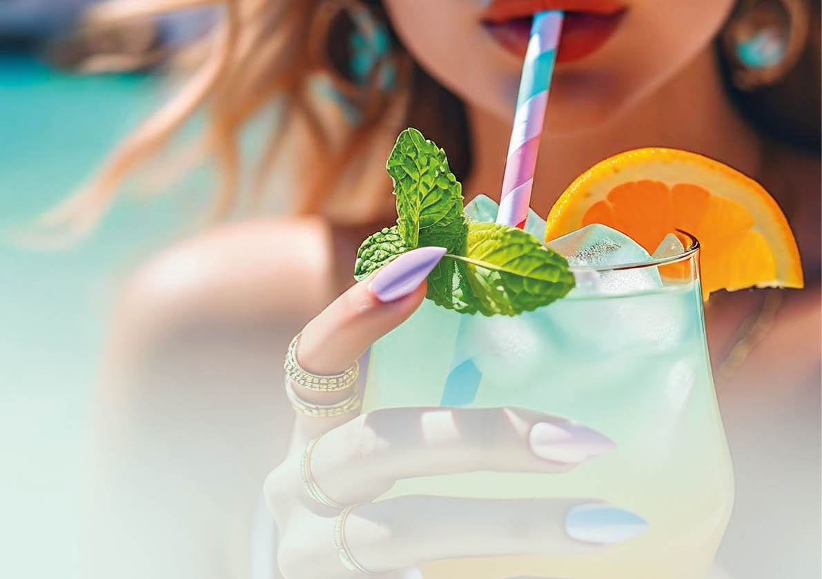 A woman holding a straw with a drink in it. Description generated by AI