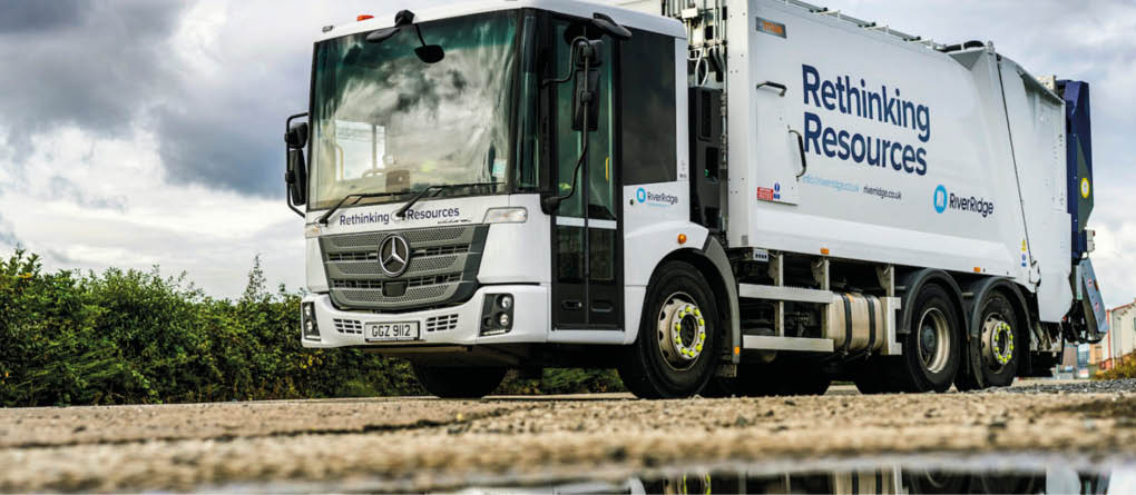 A large white garbage truck is parked on a wet road. AI generated content