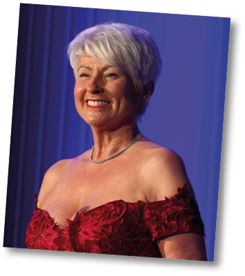 A woman wearing a red dress and a necklace. Description generated by AI
