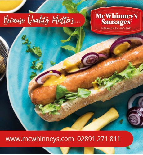 A hot dog with onions and mustard on a blue plate. Description generated by AI