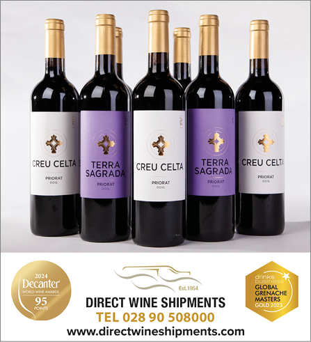 Five bottles of wine are displayed in a row. Description generated by AI