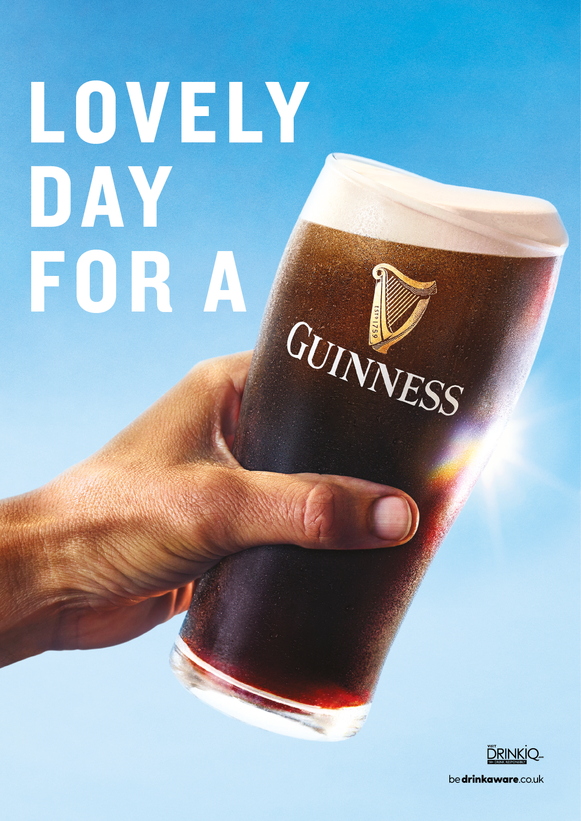 A hand holding a glass of Guinness. Description generated by AI