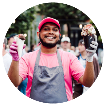 Person wearing a pink shirt and a gray strap over the shoulder. Description generated by AI