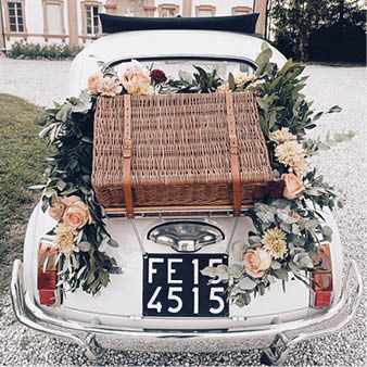 Back of a vintage wedding car with suitcase and decoration ideas to celebrate the best Just married.
