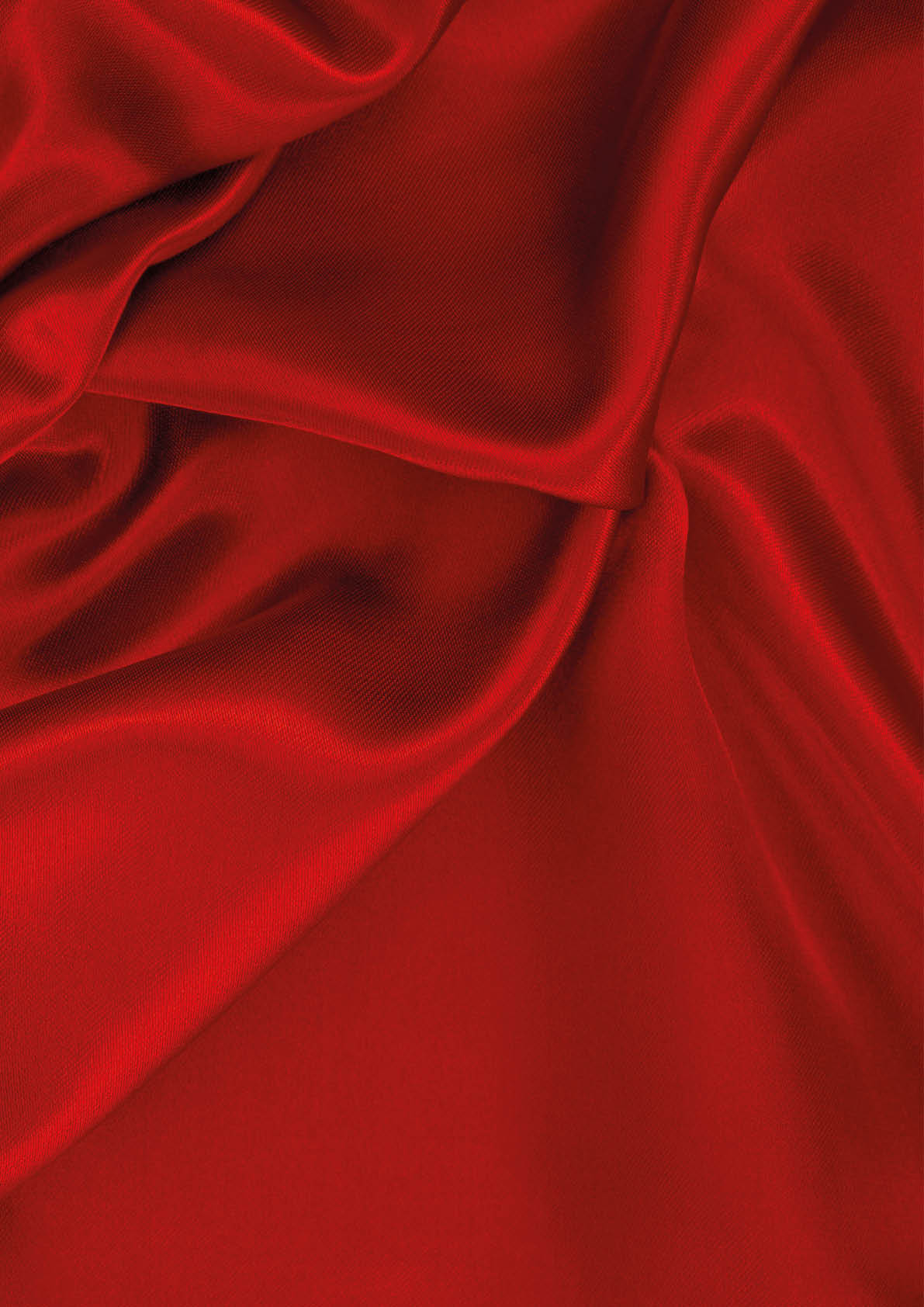 Smooth red fabric with soft folds and gentle shadows creating a flowing texture. Description generated by AI