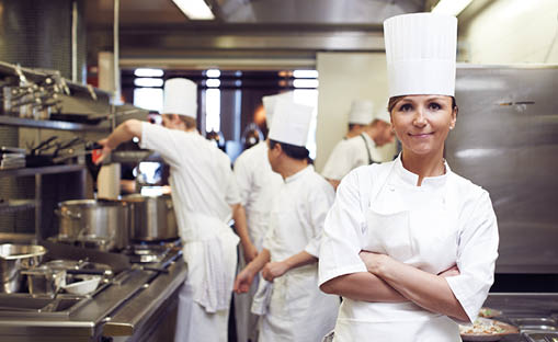 Restaurant, chef and portrait of woman with arms crossed for culinary service, job and pride in kitchen. Fine dining, person and face of cook in food industry for catering, career and hospitality
