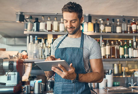 Man in restaurant, tablet and small business with inventory check, entrepreneur in hospitality industry and connectivity. Male owner, scroll and cafe franchise with digital admin and stock taking