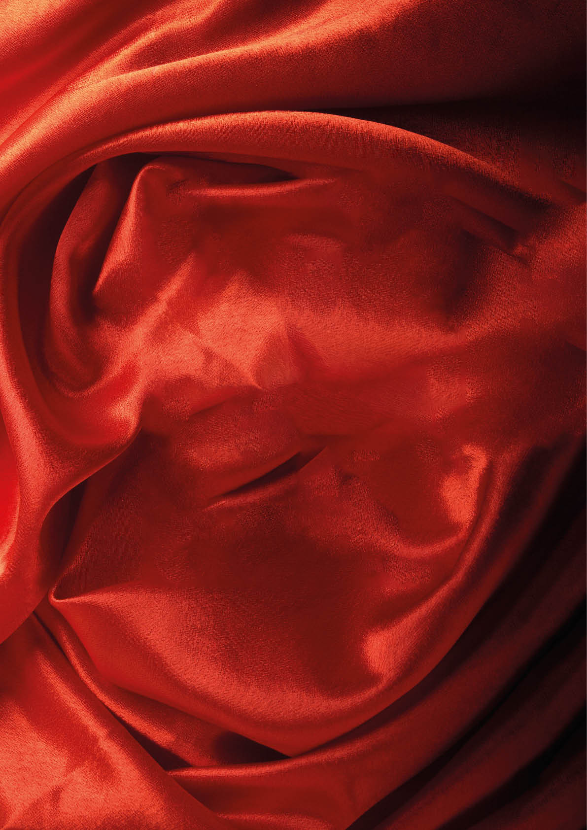 Red crumpled velvet with smooth curved rectangular plot as background.