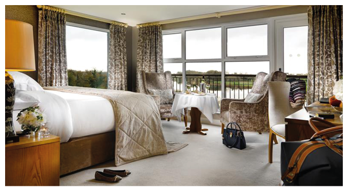 A bedroom with a bed, chair, and table. Description generated by AI