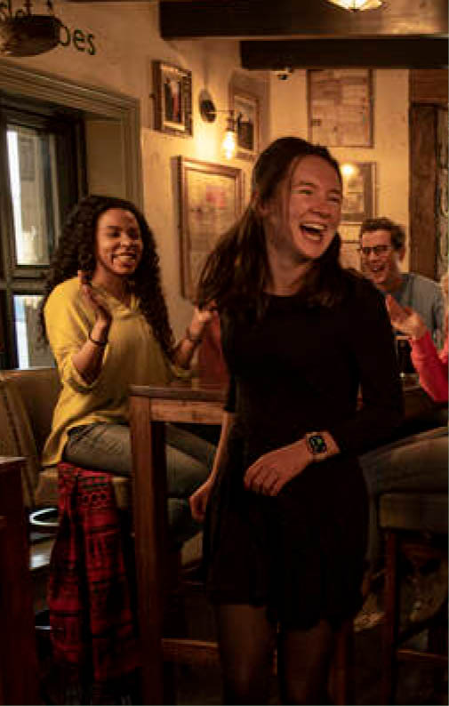 A man and woman are dancing in a bar. Description generated by AI