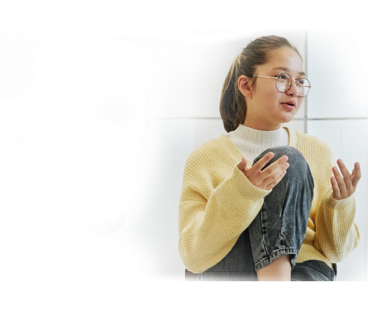 A woman wearing glasses and a yellow sweater. Description generated by AI