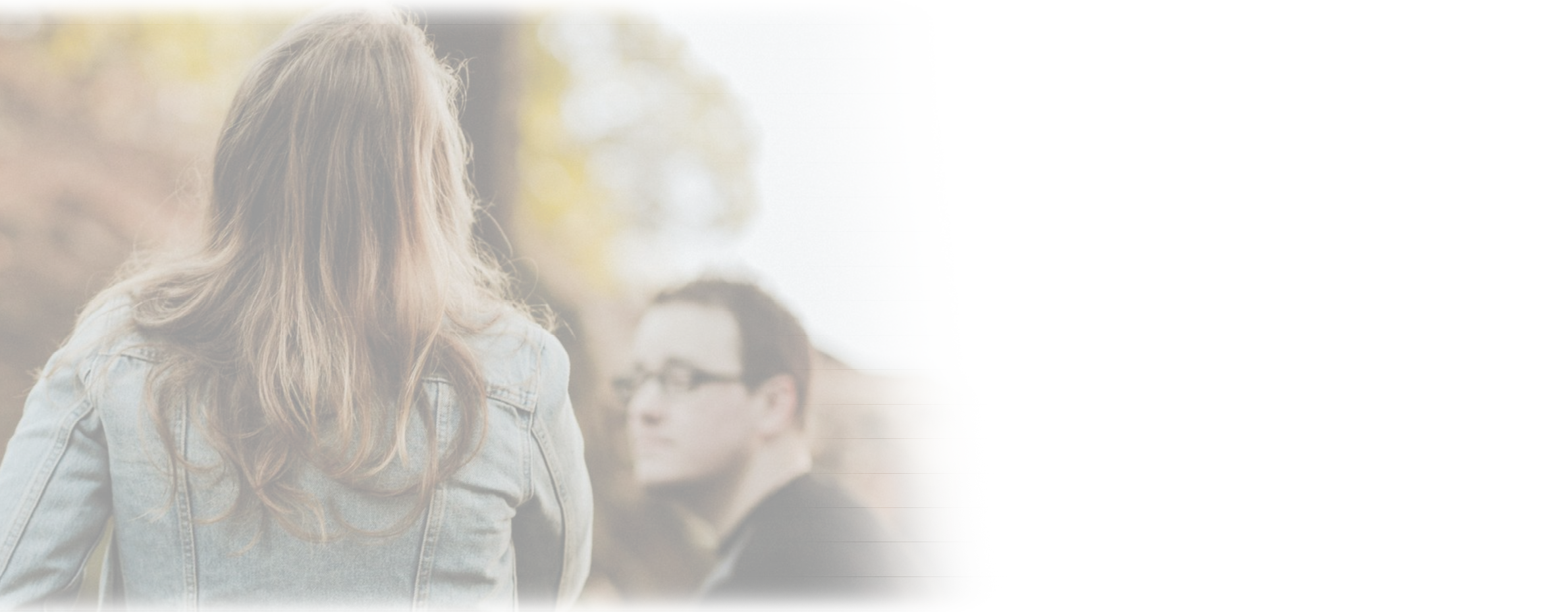 Three people standing in a wooded area. Description generated by AI