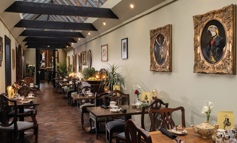 A restaurant with wooden tables and chairs. Description generated by AI