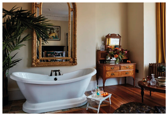 A large white bathtub with a black drain. Description generated by AI