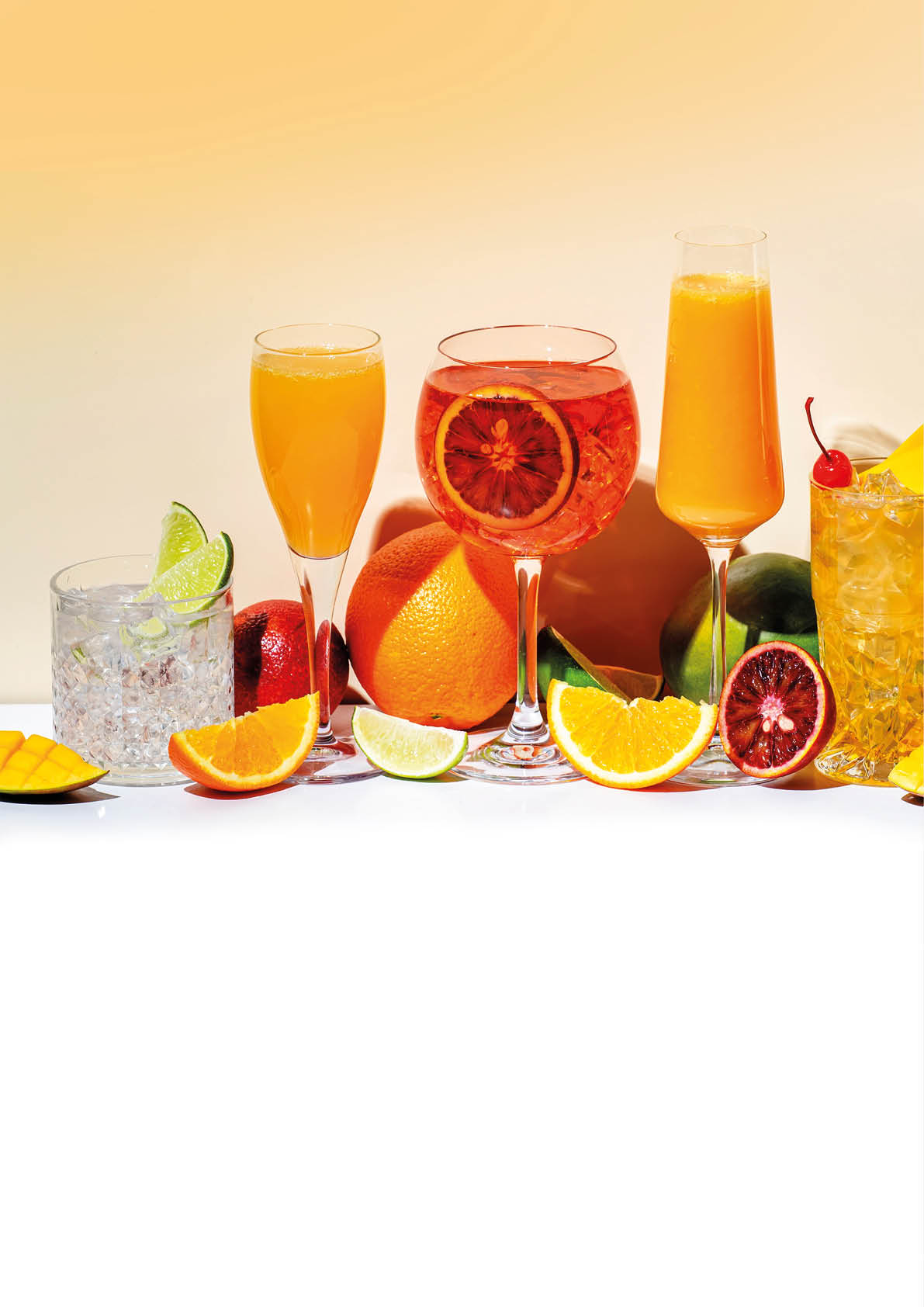 A table with a variety of drinks and fruit. Description generated by AI