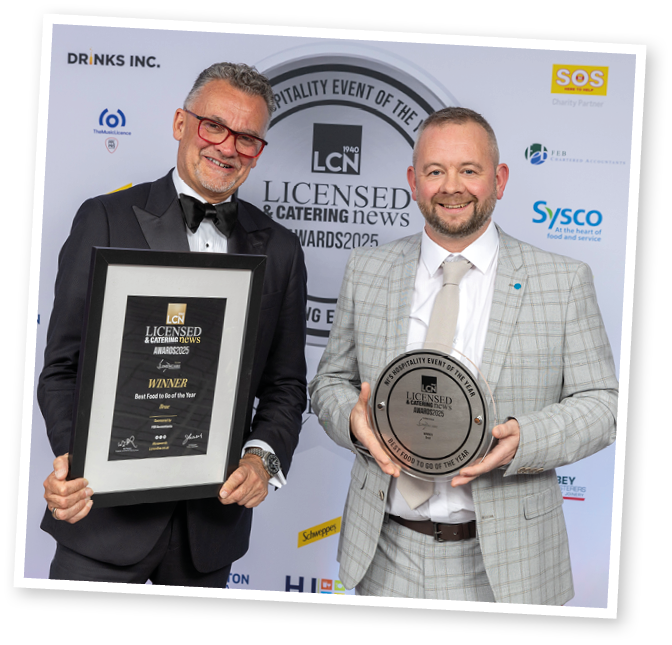 Two men holding awards. Description generated by AI